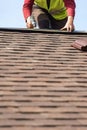 Workman install element of tile roof on new home under construction