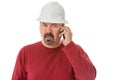 Workman looking confused talking on a mobile