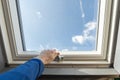 Workman open new plastic window on roof Royalty Free Stock Photo
