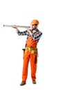 workman in orange overall and hard hat checking spirit level