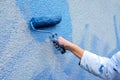 Workman painting the wall in blue Royalty Free Stock Photo