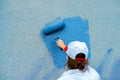 Workman painting the wall in blue Royalty Free Stock Photo