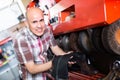 Workman polishing boots in workshop