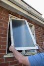 Workman removing old broken window from building Royalty Free Stock Photo