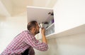 Workman repair door on the cabinet in the kitchen Royalty Free Stock Photo