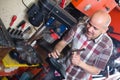 Workman repairing pair of shoes