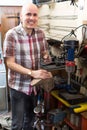 Workman repairing pair of shoes Royalty Free Stock Photo