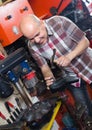 Workman repairing pair of shoes Royalty Free Stock Photo