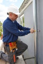 Workman Replacing Guttering On Exterior Of House Royalty Free Stock Photo