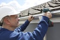 Workman Replacing Guttering On Exterior Of House Royalty Free Stock Photo