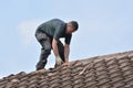 Workman replacing roof tiles and ridge tiles Royalty Free Stock Photo