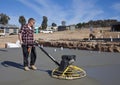 Workman smoothing newly poured concrete Royalty Free Stock Photo