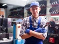 Workman standing near car at auto repair