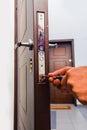 Workman standing near the door and fixing it Royalty Free Stock Photo