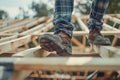 Workman in Sturdy Boots Treads on Unfinished Roof