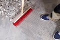 Workman sweeping the rubble on the floor with a broom Royalty Free Stock Photo