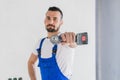 Bearded foreman shows a drill to the camera Royalty Free Stock Photo