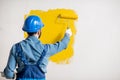 Workman painting wall indoors Royalty Free Stock Photo