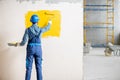 Workman painting wall indoors Royalty Free Stock Photo
