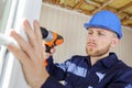 workman using cordless drill while installing pvc windows Royalty Free Stock Photo