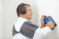 workman using cordless sander on interior wall Royalty Free Stock Photo