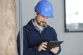 workman using tablet pc in renovation property Royalty Free Stock Photo