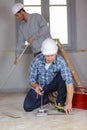 Workman using tile cutter