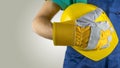 Workman wearing a glove holding a hardhat