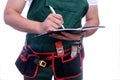 Workman writing in diary isolated on white. Man wearing coverall and tool belt Royalty Free Stock Photo
