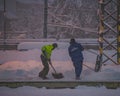 Workmans with shovel in snowy morning in Ceske Budejovice station CZ 02 12 2023