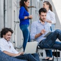 Workmates at creative agency meeting for brainstorming on terrace