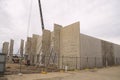 A tilt-up warehouse of prefabricated concrete panels under construction.