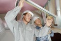 Workmen erecting wall insulation panels in construction site Royalty Free Stock Photo