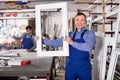 Workmen inspecting PVC manufacturing output in workshop Royalty Free Stock Photo