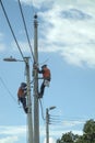 Workmen installing electrical cables