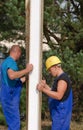 Workmen installing insulation on a building site Royalty Free Stock Photo