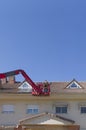 Workmen installing solar panels on the roof of a terraced house Royalty Free Stock Photo