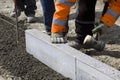 Workmen laying granite slabs