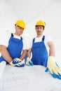 Workmen looking at house design Royalty Free Stock Photo