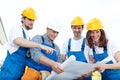 Workmen looking at house design Royalty Free Stock Photo