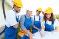 Workmen looking at house design Royalty Free Stock Photo