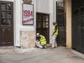 Workmen prepare wall for painting on Playhouse Theatre, London, Royalty Free Stock Photo