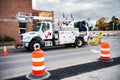 workmen Verizon lowering cable into a manhole (digital composite). Verizon special equipment for Internet debugging