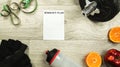 Workout concept. Bottle, fruit, dumbbell, gloves and measuring tape.