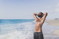 Workout exercise concept.Healthy Handsome Active Man With Fit Muscular Body dreaming on the beach at the morning. Sporty Royalty Free Stock Photo
