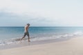 Workout exercise concept.Healthy Handsome Active Man With Fit Muscular Body running on the beach on the morning. Sporty Royalty Free Stock Photo