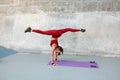 Workout. Fitness Girl Standing On Hands. Fit Woman In Fashion Sporty Outfit Doing Split Twine In Air. Royalty Free Stock Photo