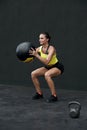 Workout. Fitness woman doing squat exercise with med ball. Sport