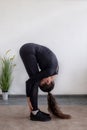 Workout at home. Athletic woman in sportswear doing stretching exercises at home in the living room. Royalty Free Stock Photo