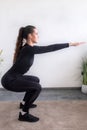 Workout at home.Athletic woman in sportswear doing stretching exercises at home in the living room. Royalty Free Stock Photo